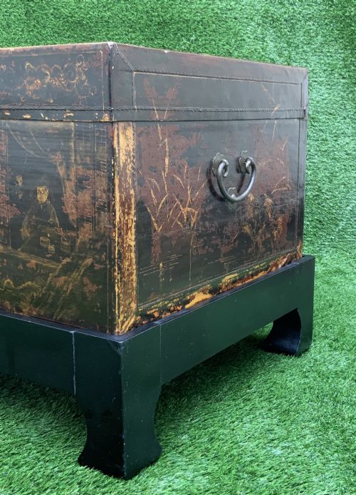 fig 2. A large rectangular Japanese lacquered storage chest with gilt figurative Chinoiserie scenes set upon a black painted wooden stand.