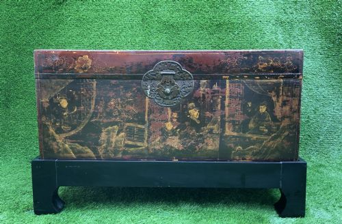fig 5. A large rectangular Japanese lacquered storage chest with gilt figurative Chinoiserie scenes set upon a black painted wooden stand.