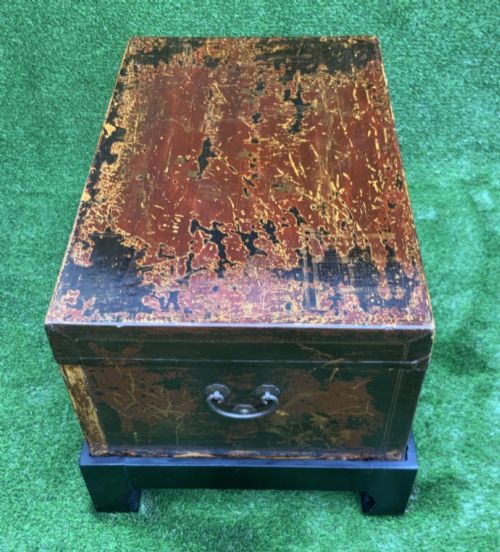 fig 8. A large rectangular Japanese lacquered storage chest with gilt figurative Chinoiserie scenes set upon a black painted wooden stand.
