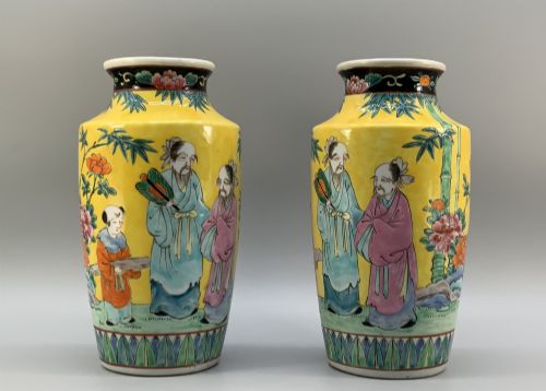 fig 3. A pair of yellow ground Chinese porcelain vases decorated with painted figures, floral motifs, and green leaf borders around the base.