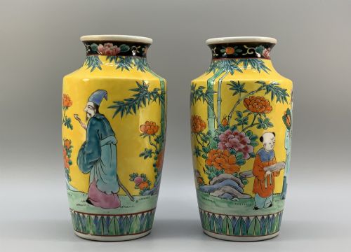 fig 4. A pair of yellow ground Chinese porcelain vases decorated with painted figures, floral motifs, and green leaf borders around the base.