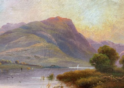 fig 3. A nineteenth-century oil painting on canvas depicting a Scottish loch and mountains illuminated by a sunset, displayed within a gilt carved frame.