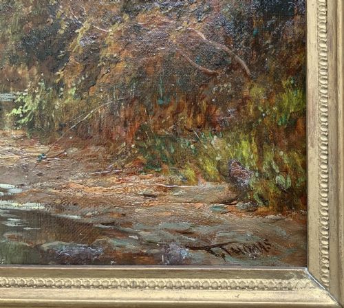 fig 7. A Victorian landscape oil painting depicting a rural scene with a horse-drawn cart crossing a stream beside mature trees and a cottage, set in an ornate gilt frame.