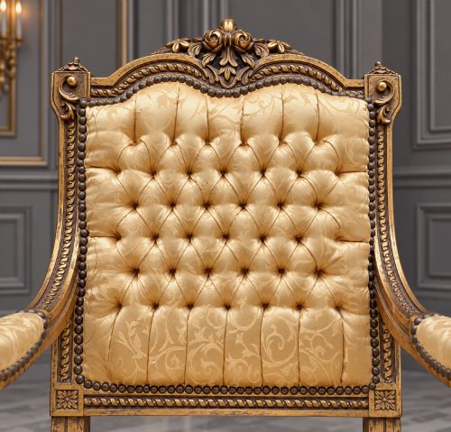 fig 6. A pair of 19th-century giltwood open armchairs featuring carved leaf detailing, button-tufted gold damask upholstery, and fluted front legs.