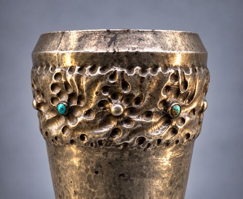 fig 6. An Arts and Crafts hammered pewter vase featuring raised geometric support fins, a textured upper band, and inlaid turquoise cabochons.