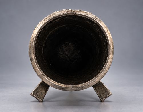 fig 9. An Arts and Crafts hammered pewter vase featuring raised geometric support fins, a textured upper band, and inlaid turquoise cabochons.