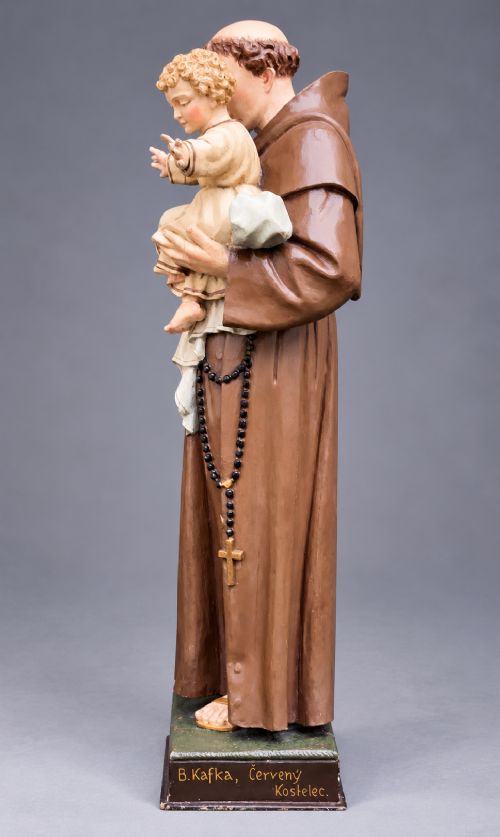 fig 3. An antique polychrome carved wood sculpture depicting Saint Anthony in a brown Franciscan habit holding the Christ Child.