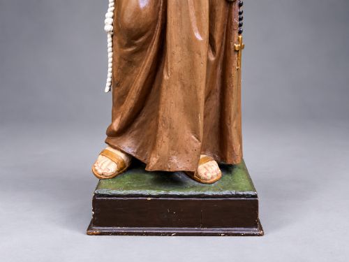 fig 7. An antique polychrome carved wood sculpture depicting Saint Anthony in a brown Franciscan habit holding the Christ Child.