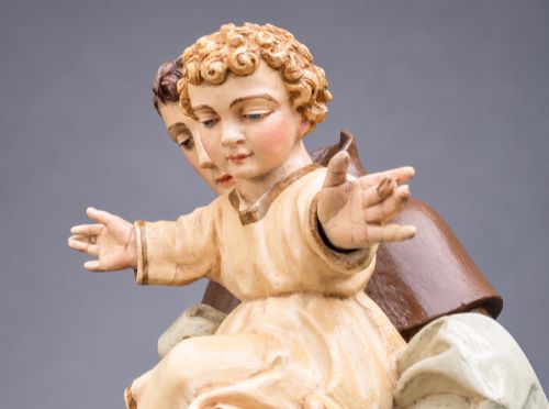 fig 8. An antique polychrome carved wood sculpture depicting Saint Anthony in a brown Franciscan habit holding the Christ Child.