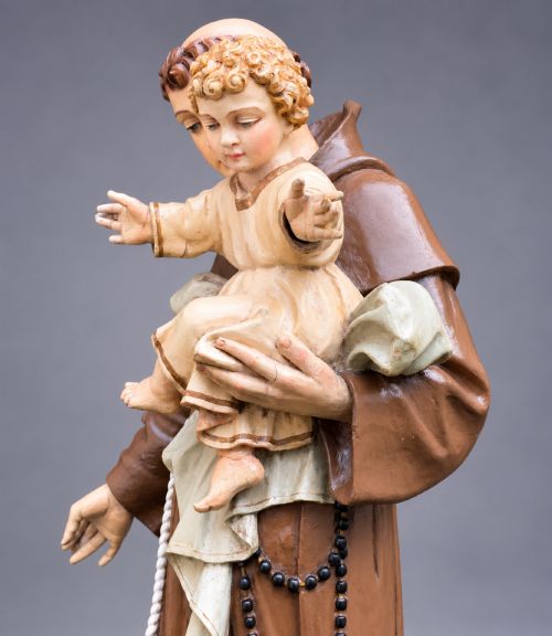 fig 9. An antique polychrome carved wood sculpture depicting Saint Anthony in a brown Franciscan habit holding the Christ Child.