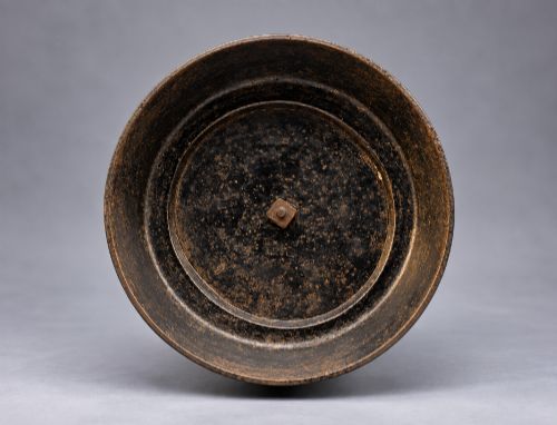 fig 10. A nineteenth-century dark patinated bronze sculpture depicting two fishermen standing in a small vessel atop sculpted ocean waves, mounted on a rounded base.