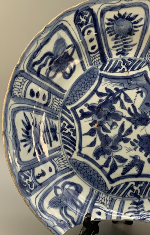 fig 6. A late 16th-century Chinese Kraak blue and white porcelain charger with panelled floral motifs, shown displayed alongside detached rim fragments.