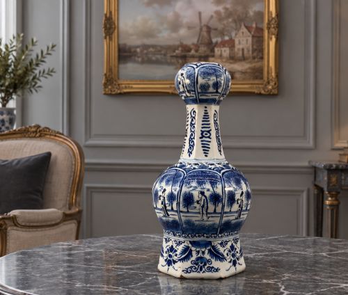 fig 1. A 17th-century hexagonal Dutch Delft blue and white faience vase decorated with hand-painted chinoiserie figures and floral motifs.