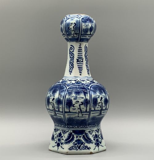 fig 2. A 17th-century hexagonal Dutch Delft blue and white faience vase decorated with hand-painted chinoiserie figures and floral motifs.
