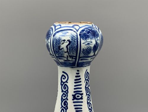 fig 4. A 17th-century hexagonal Dutch Delft blue and white faience vase decorated with hand-painted chinoiserie figures and floral motifs.