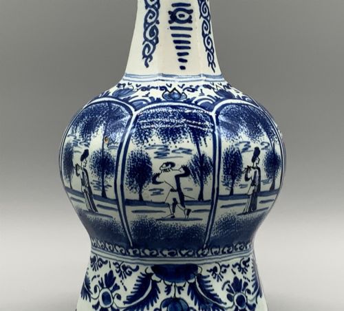 fig 5. A 17th-century hexagonal Dutch Delft blue and white faience vase decorated with hand-painted chinoiserie figures and floral motifs.