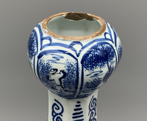 fig 7. A 17th-century hexagonal Dutch Delft blue and white faience vase decorated with hand-painted chinoiserie figures and floral motifs.