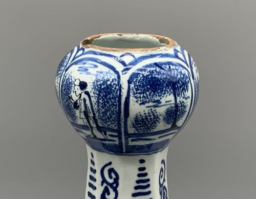 fig 8. A 17th-century hexagonal Dutch Delft blue and white faience vase decorated with hand-painted chinoiserie figures and floral motifs.