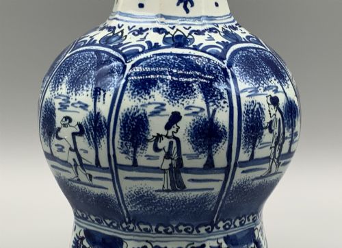 fig 10. A 17th-century hexagonal Dutch Delft blue and white faience vase decorated with hand-painted chinoiserie figures and floral motifs.