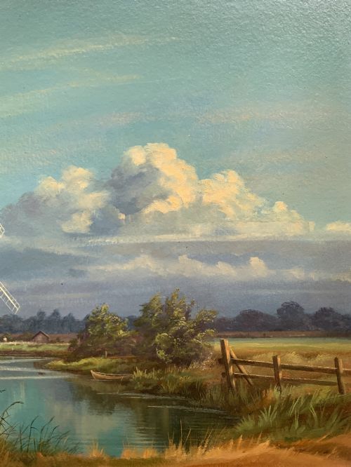 fig 4. An oil painting depicting Horsey Mill set amidst the Norfolk Broads under a cloud-filled sky, presented in an elaborate gilded swept frame.