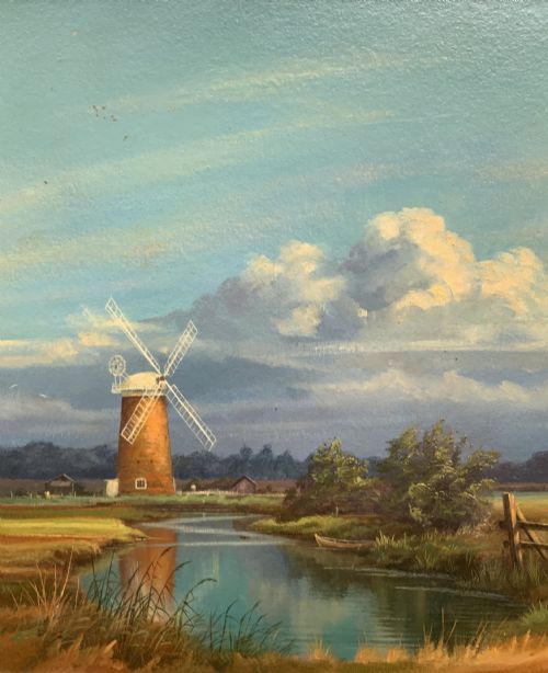 fig 5. An oil painting depicting Horsey Mill set amidst the Norfolk Broads under a cloud-filled sky, presented in an elaborate gilded swept frame.