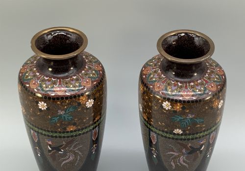 fig 5. A pair of Japanese Meiji period cloisonne enamel vases featuring detailed phoenix birds, floral motifs, and geometric borders on a dark background.