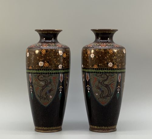 fig 7. A pair of Japanese Meiji period cloisonne enamel vases featuring detailed phoenix birds, floral motifs, and geometric borders on a dark background.