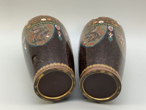 fig 9. A pair of Japanese Meiji period cloisonne enamel vases featuring detailed phoenix birds, floral motifs, and geometric borders on a dark background.