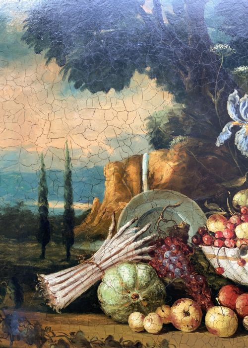 fig 10. A classical oil painting displaying a bowl of fruit, a urn with flowers, asparagus, and melons set against a dark landscape backdrop within a carved silver-grey frame.