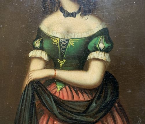 fig 5. A framed miniature oil portrait depicting a Victorian woman with dark curly hair in a green and red dress, enclosed in a gilded wooden frame with egg-and-dart detail.