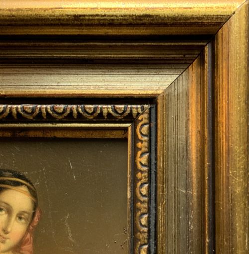 fig 6. A framed 19th-century miniature oil painting depicting a seated woman in a teal dress and dark shawl holding a fan.