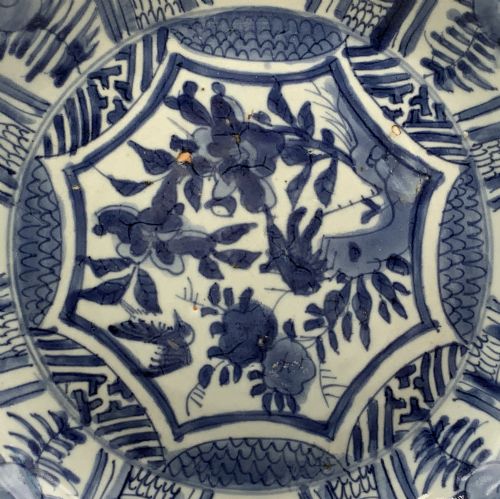 fig 7. A circular 16th-century Chinese Kraak porcelain charger decorated in cobalt blue underglaze featuring a central floral scene surrounded by a panelled foliate rim.