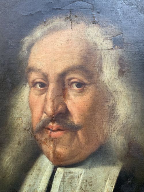 fig 5. An oval 17th-century oil painting depicting a gentleman with grey hair, a moustache, and white falling bands collar in a carved gold frame.