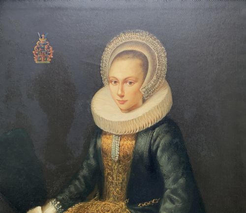 fig 4. A pair of large framed full-length oil portraits depicting a lady in a dark green gown and a gentleman in a black doublet, both wearing pleated ruff collars.