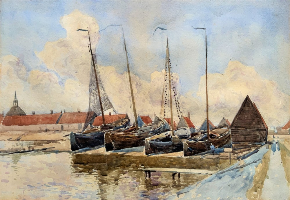 A 19th-century watercolour painting depicting several wooden sailing boats docked at a boat yard alongside buildings, housed within a wide gilt mount and thin gilt frame. View II