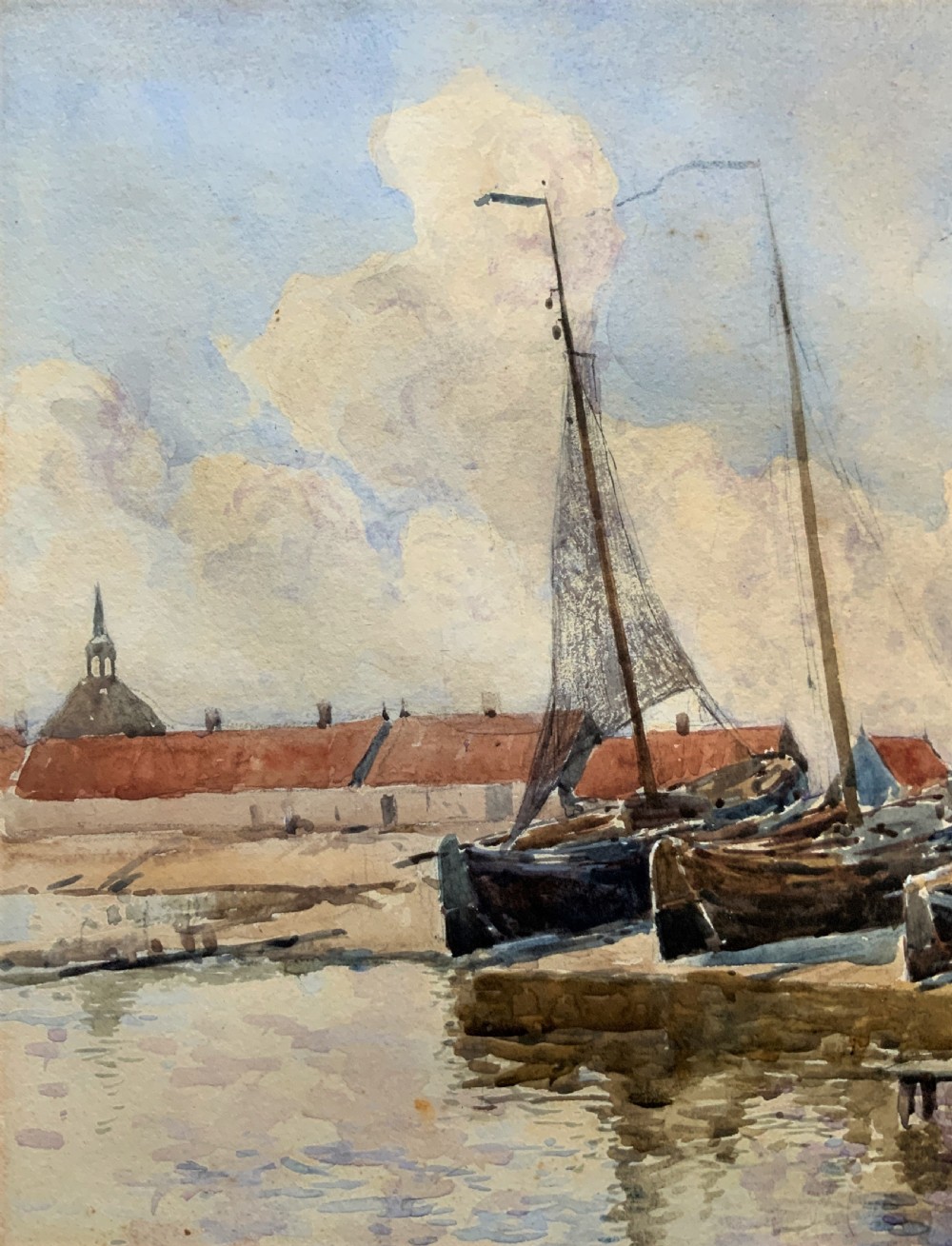 A 19th-century watercolour painting depicting several wooden sailing boats docked at a boat yard alongside buildings, housed within a wide gilt mount and thin gilt frame. View VIII
