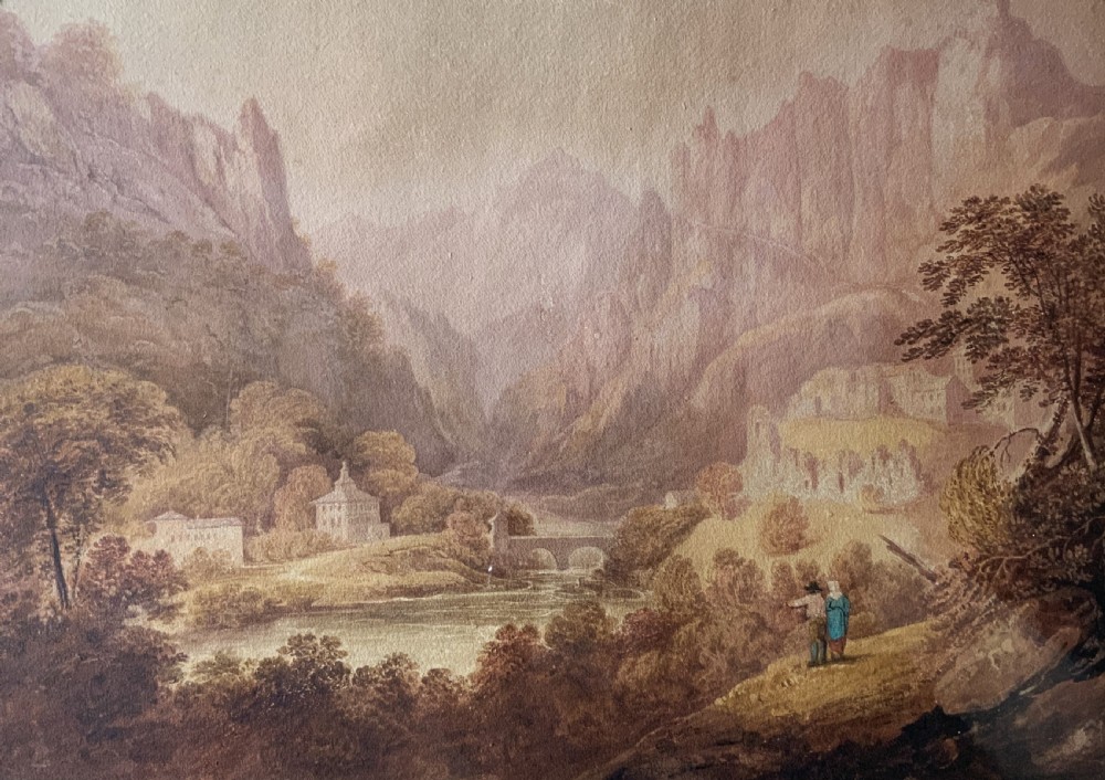 An antique 19th-century watercolour painting depicting a mountainous river landscape set within an arched cream mount and gilt wooden frame. View III