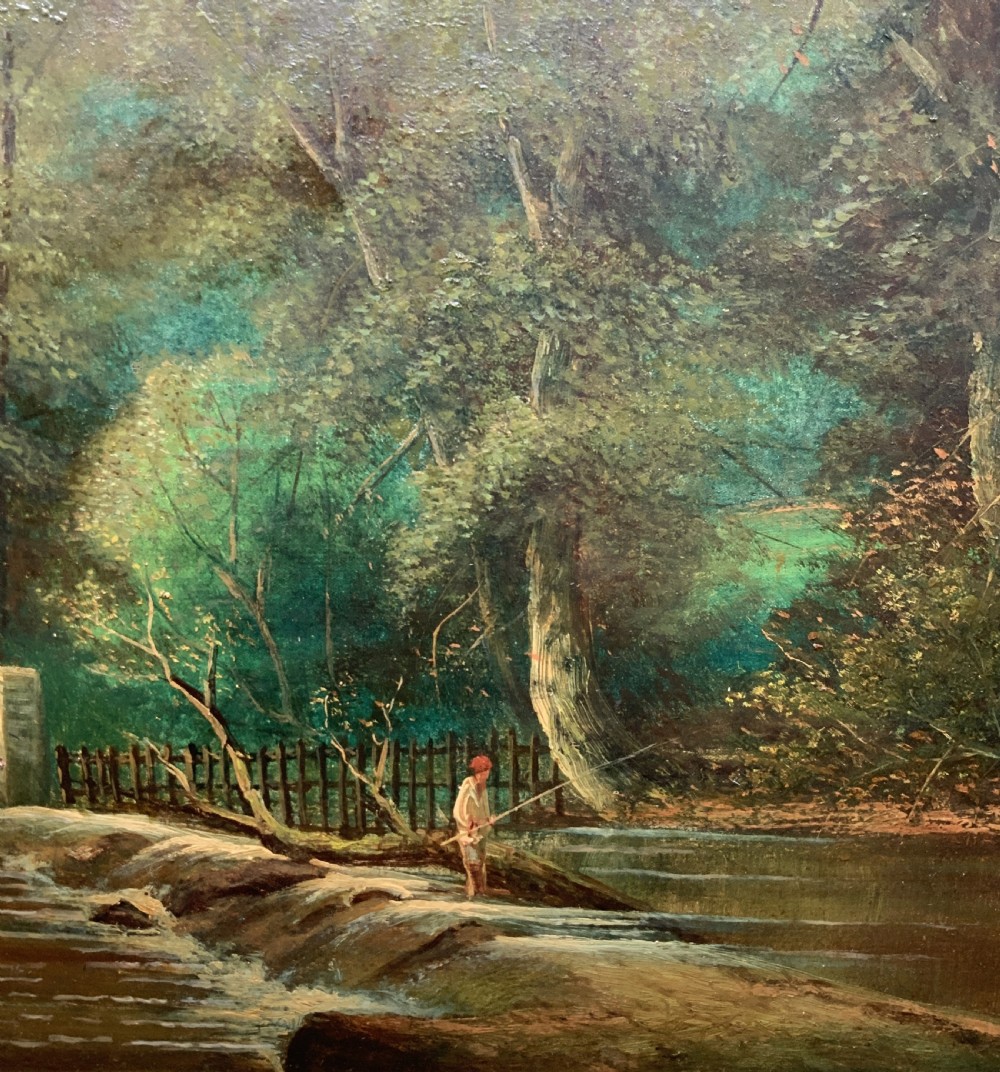An early 20th-century landscape oil painting displaying a woodland river scene with a figure fishing near a weir, encased in a deep gold frame. View V