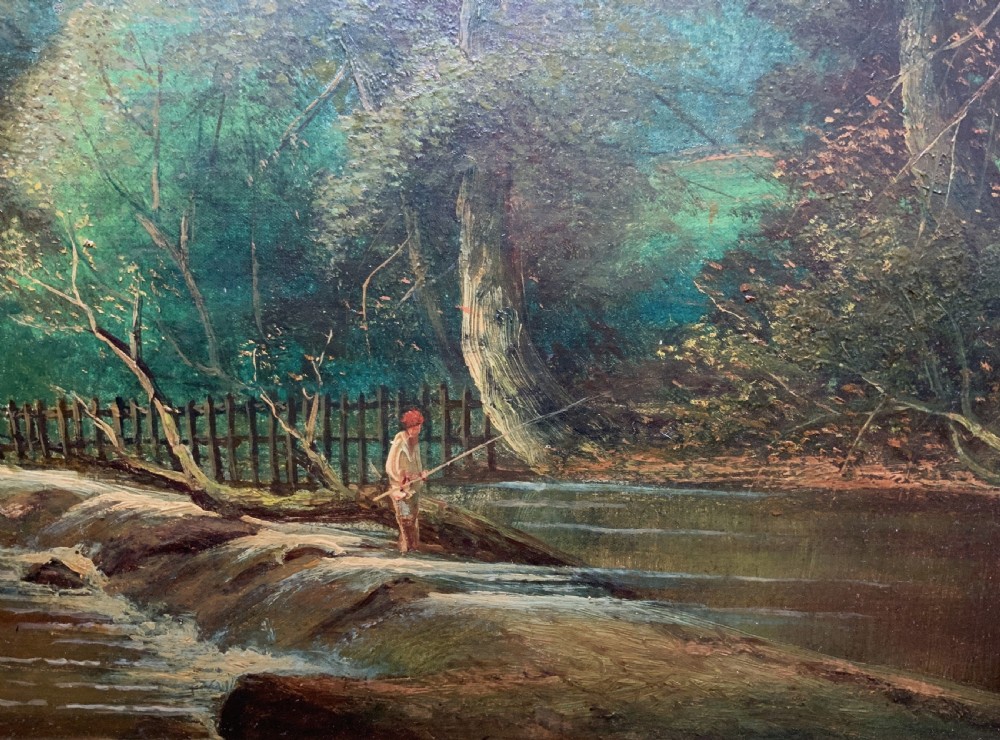 An early 20th-century landscape oil painting displaying a woodland river scene with a figure fishing near a weir, encased in a deep gold frame. View VI