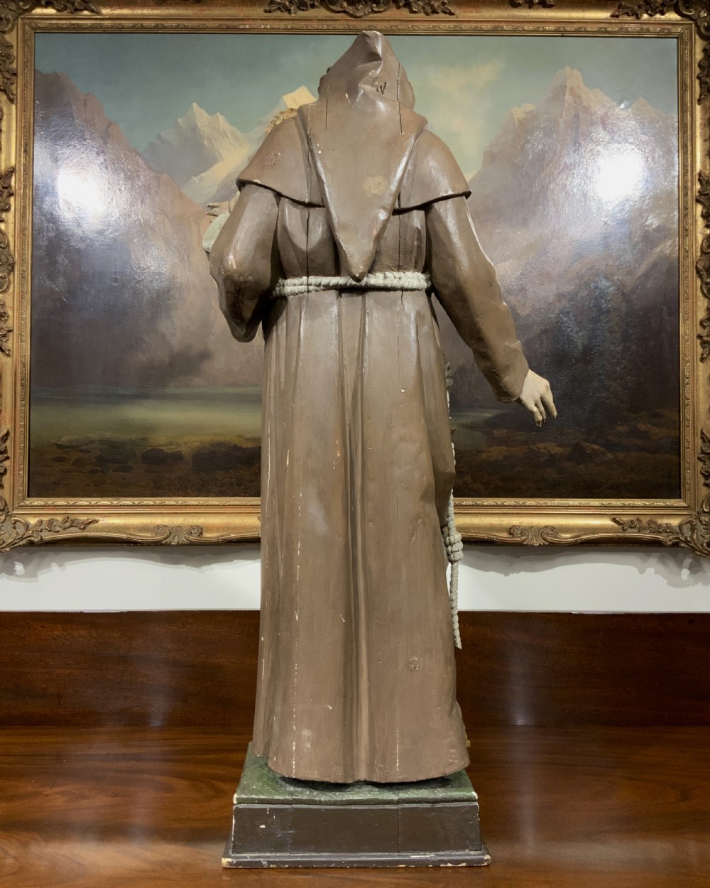 A carved polychrome wood statue depicting a saint in a brown robe holding the infant Jesus. View IX