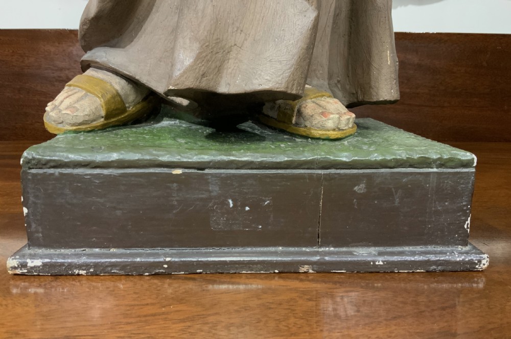 A carved polychrome wood statue depicting a saint in a brown robe holding the infant Jesus. View XX