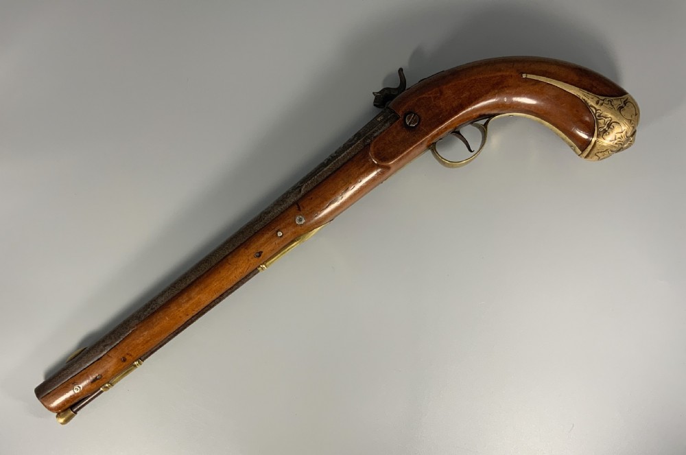 A 19th-century Regency smooth-bore percussion pistol with a carved walnut stock, engraved steel lockwork, and brass fittings. View III