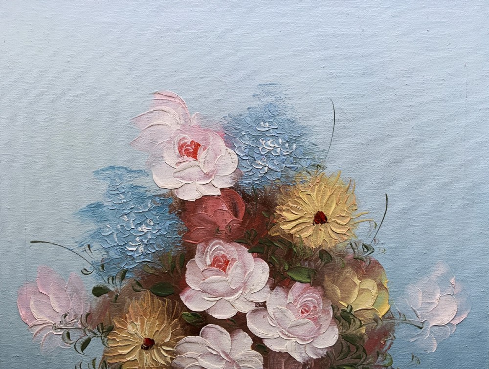 A framed post-war floral still life oil painting depicting pink, yellow, and blue flowers in a rounded blue vase within a gilt wooden frame. View IV