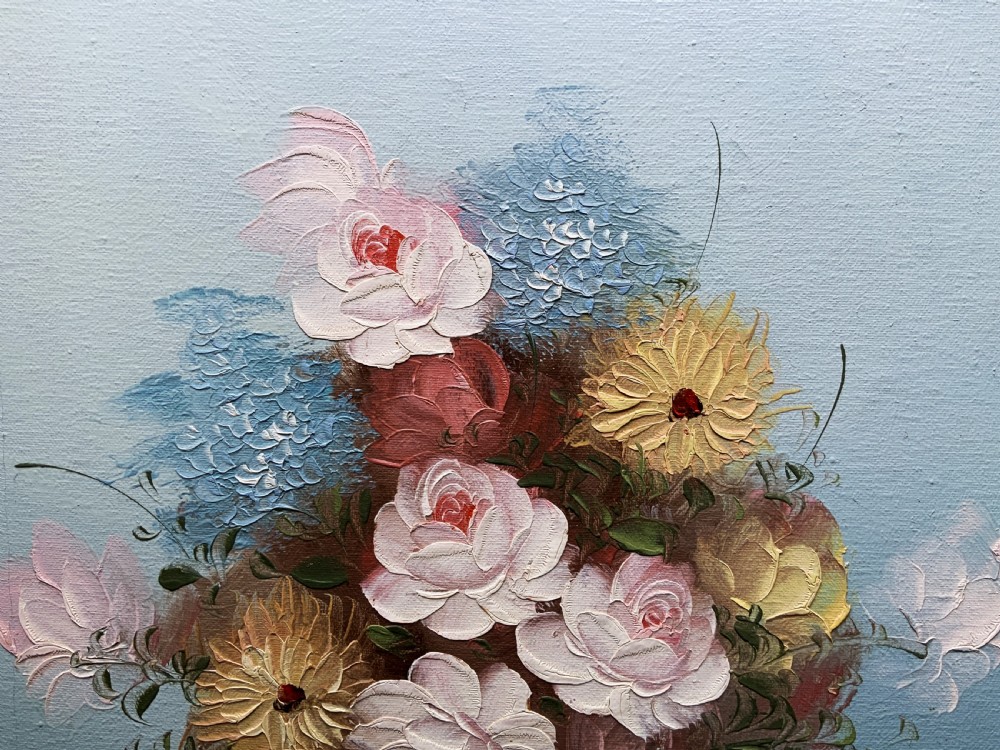 A framed post-war floral still life oil painting depicting pink, yellow, and blue flowers in a rounded blue vase within a gilt wooden frame. View V