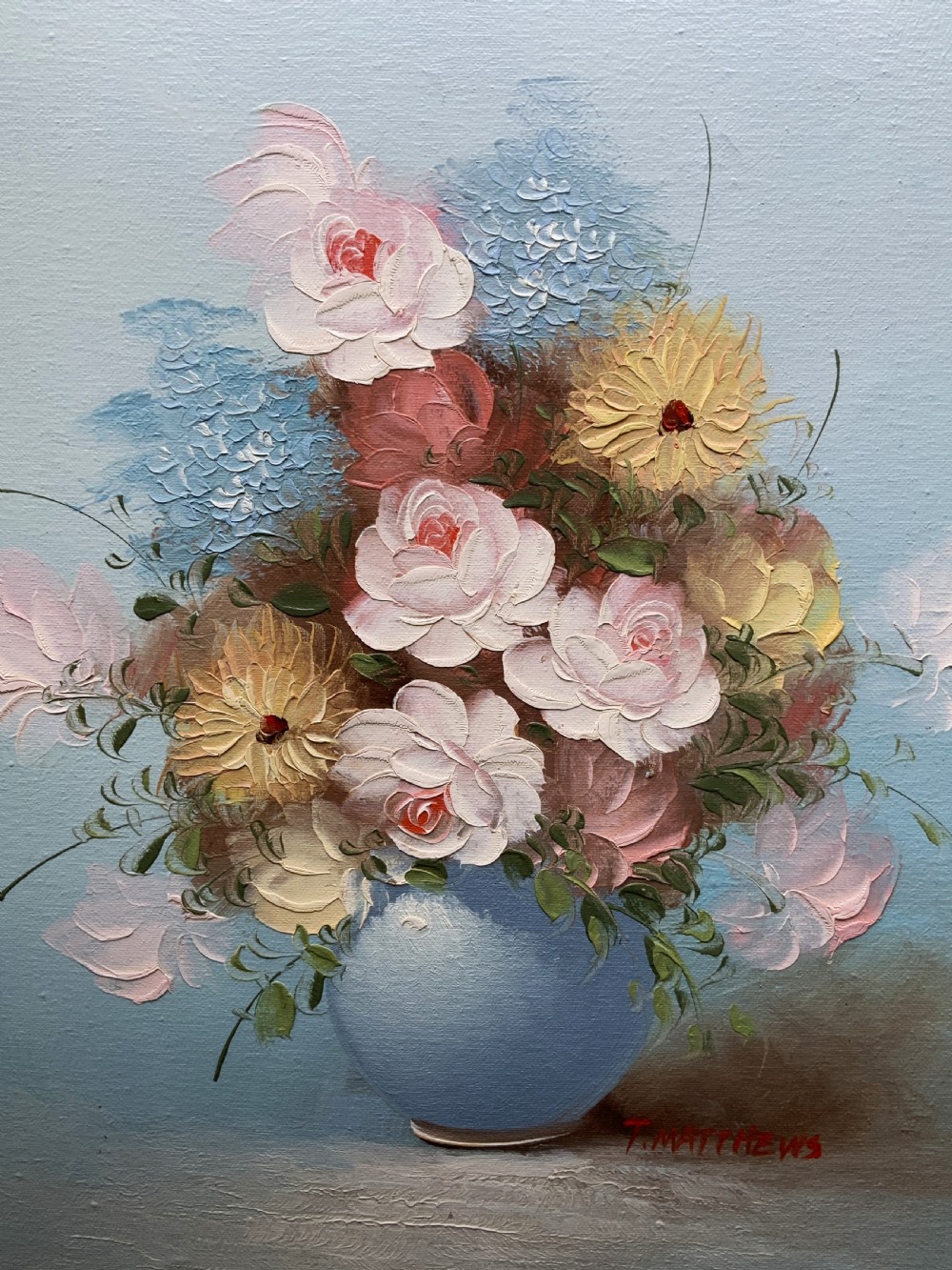 A framed post-war floral still life oil painting depicting pink, yellow, and blue flowers in a rounded blue vase within a gilt wooden frame. View VII