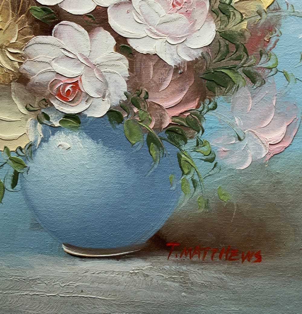 A framed post-war floral still life oil painting depicting pink, yellow, and blue flowers in a rounded blue vase within a gilt wooden frame. View VIII