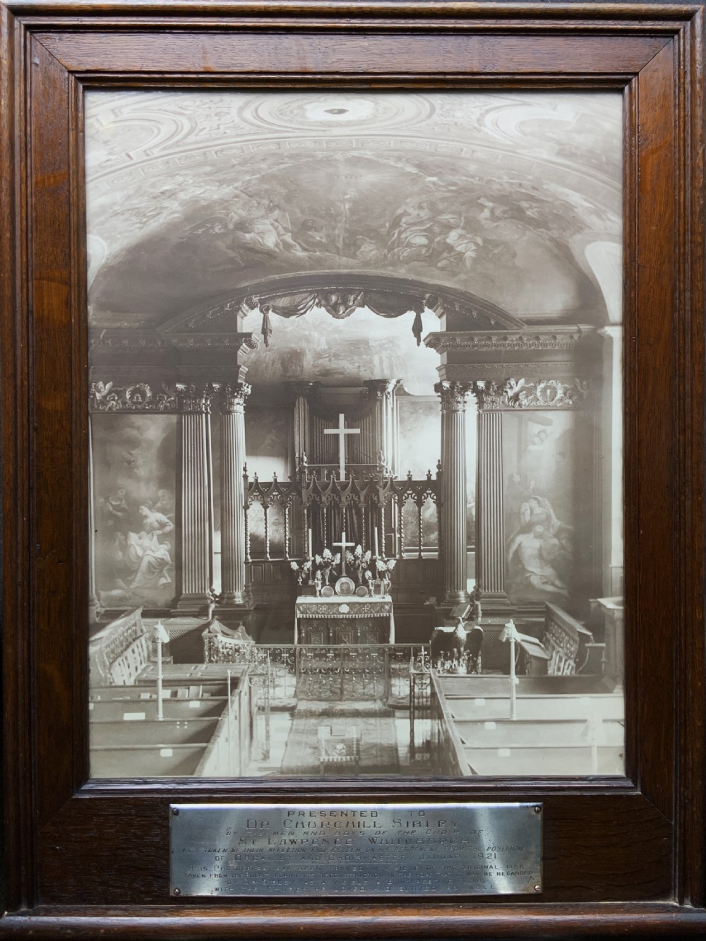 A 1921 sepia photograph depicting a church altar and choir, mounted in a moulded dark oak frame with an engraved metal presentation plaque along the bottom edge.