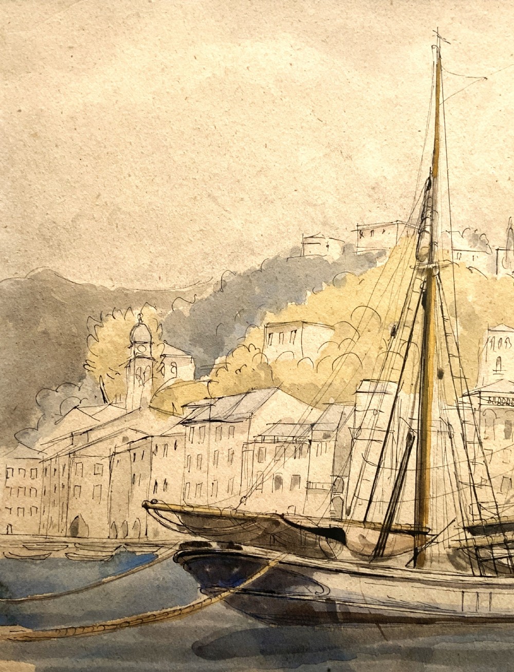 A framed 19th-century watercolour painting depicting a two-masted sailing yacht moored in a coastal harbour in front of a hillside town. View V
