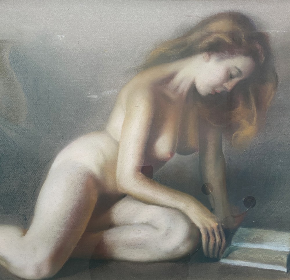 A framed mid-century pastel painting featuring a kneeling female nude reading an open book, rendered in soft neutral tones within a gilded wooden frame. View III