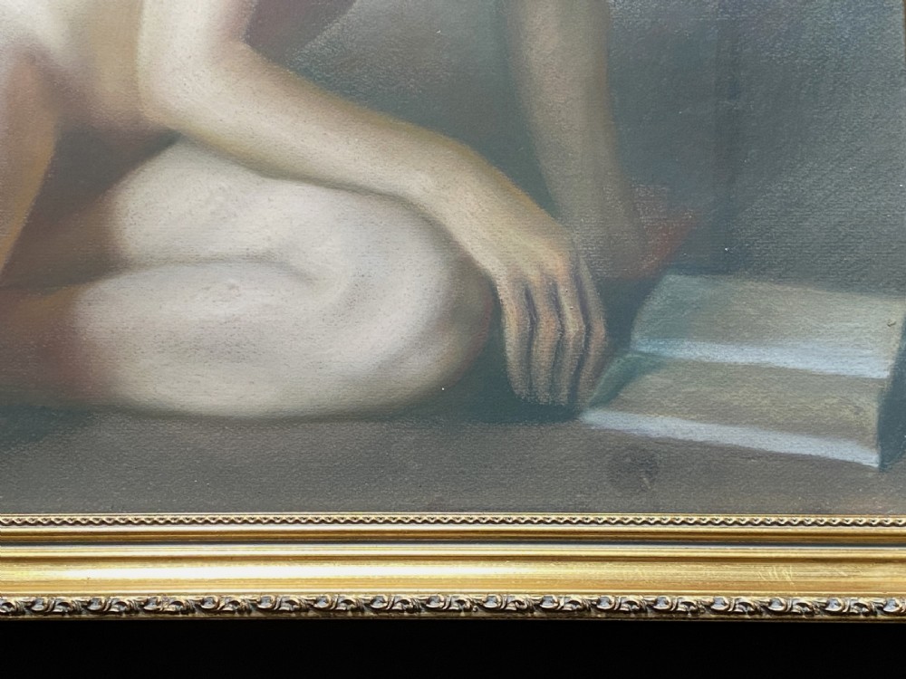 A framed mid-century pastel painting featuring a kneeling female nude reading an open book, rendered in soft neutral tones within a gilded wooden frame. View VI